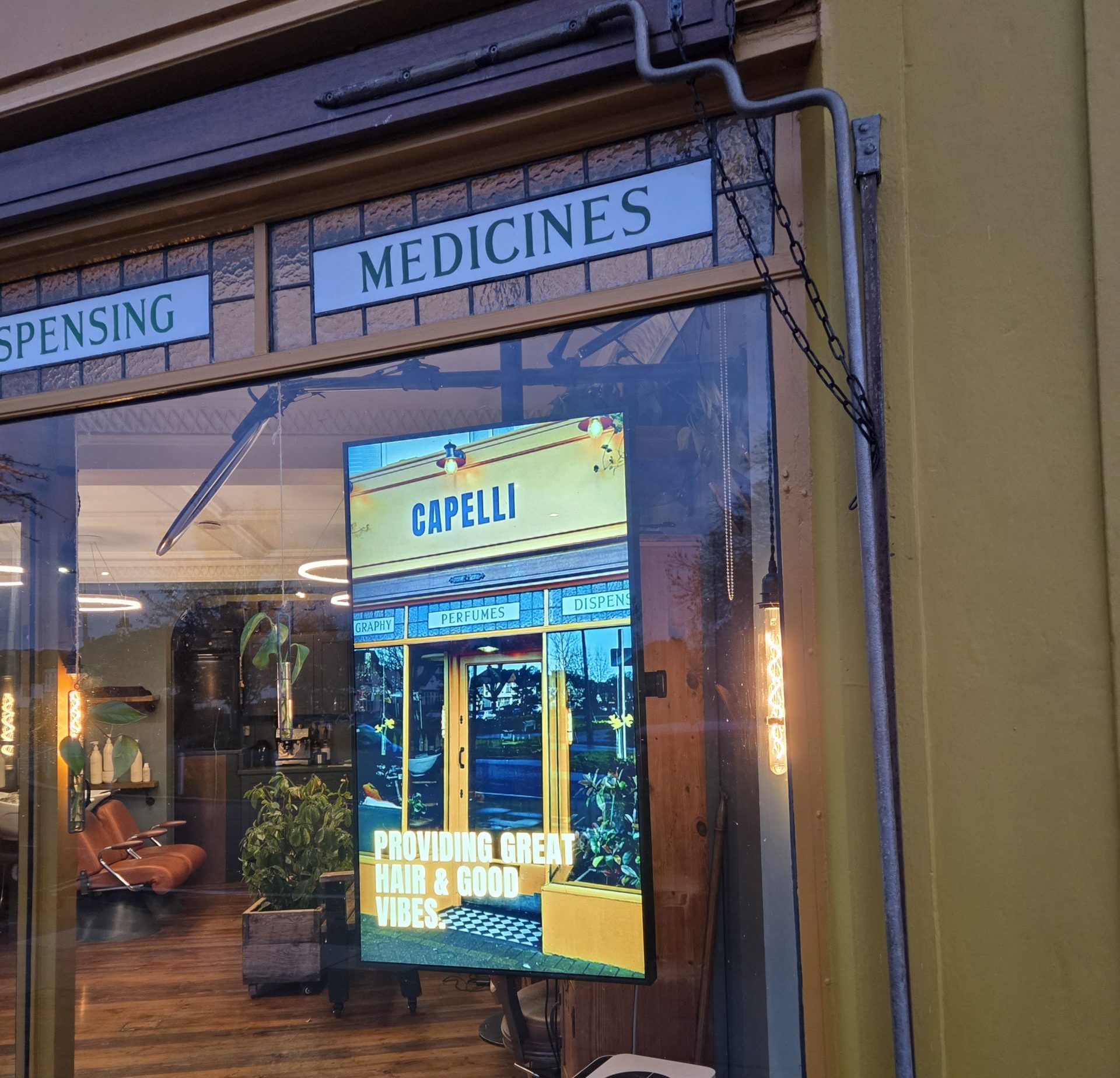 Shop window digital display helping a barber salon attract passing customers