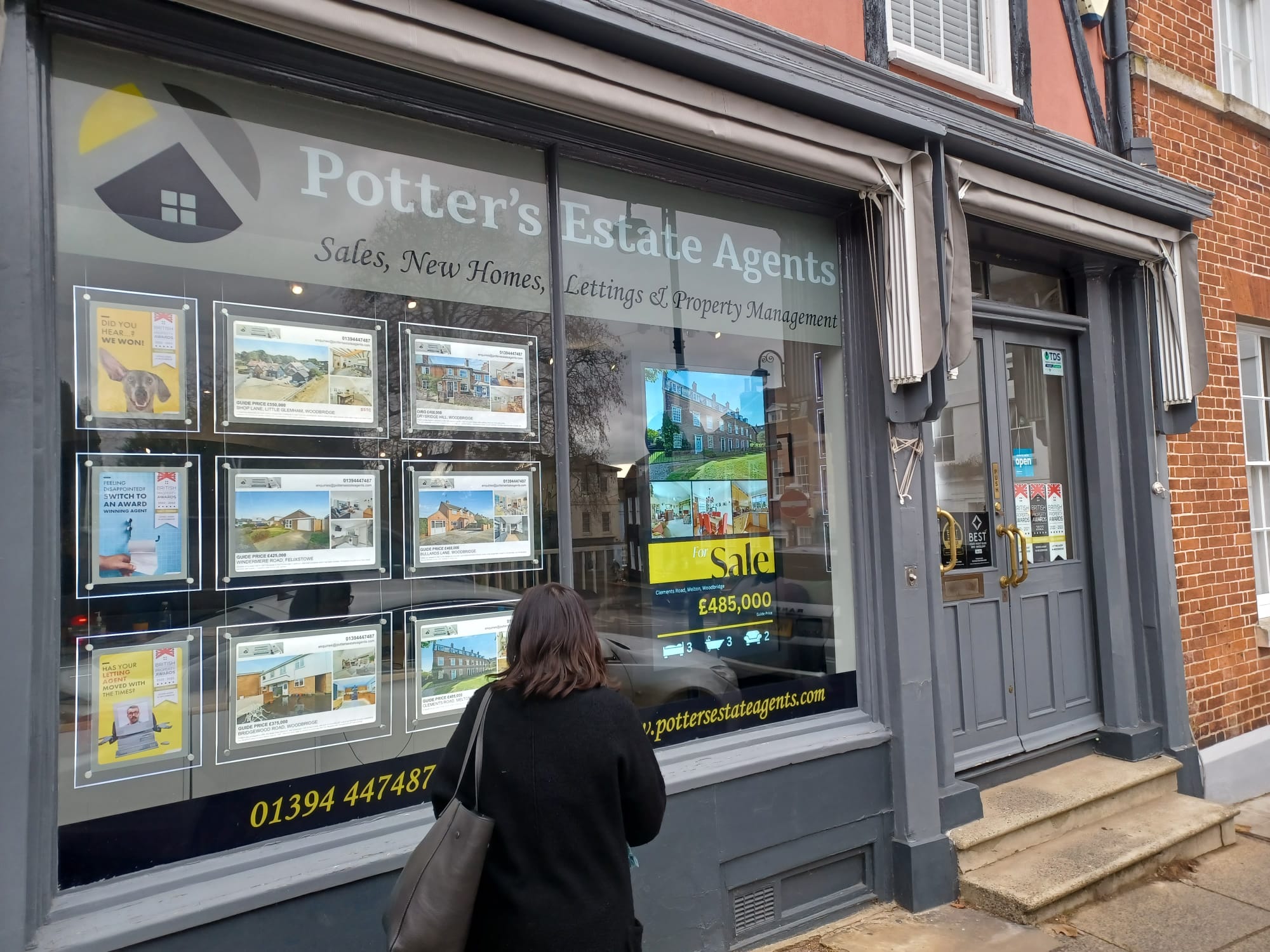 Estate agent shopfront using digital signage to advertise properties and services