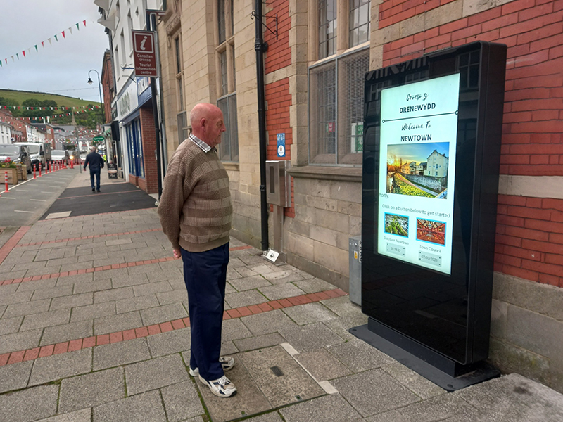 man looking at outdoor freestanding signage